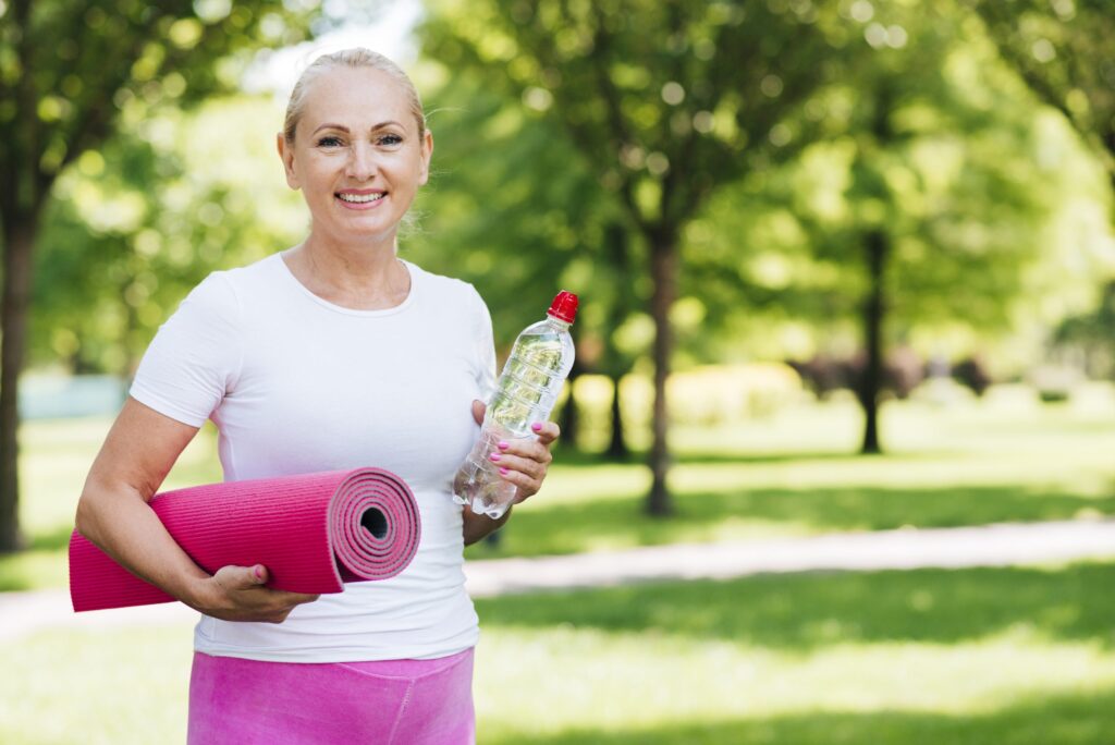 medium-shot-woman-holding-yoga-mat-scaled-1