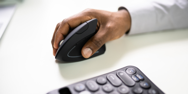 Main tenant une souris et un clavier.