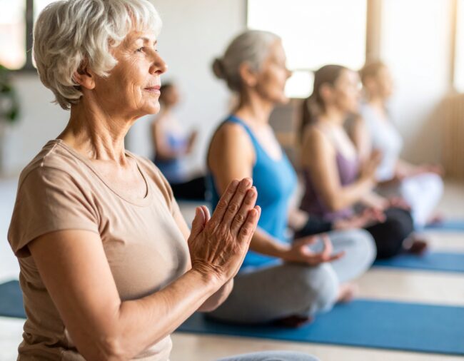 Donne in meditazione durante una lezione di yoga.